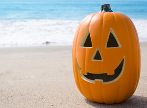 30108182 - halloween pumpkin on the sandy beach by ocean